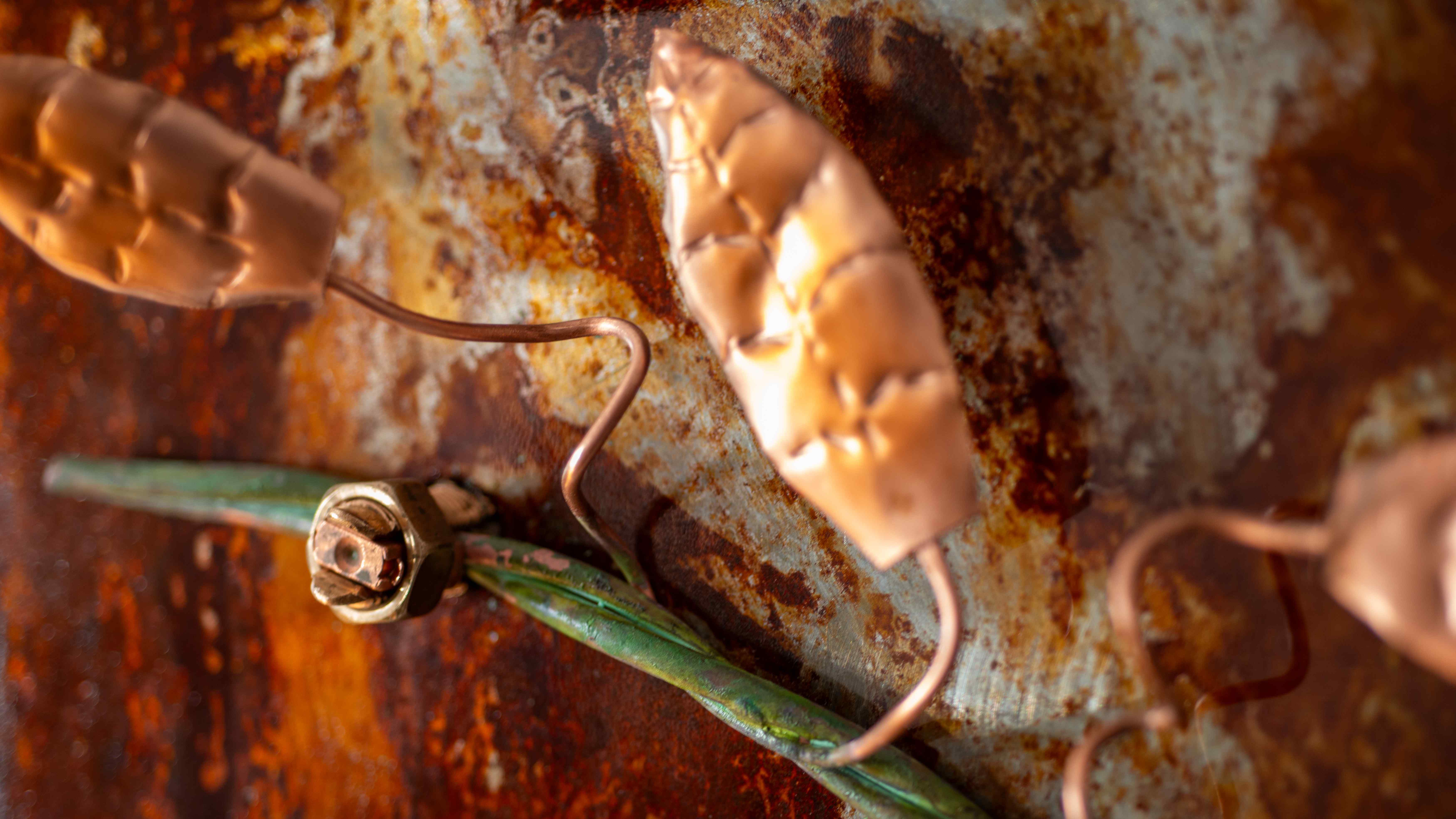 Intricate hook detail with green patina and copper finish